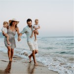 Parents with children on beach representing Generational Wealth foundations.